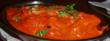 A main dish in our special spicy sauce, sprinkled with fresh green coiander A main dish in red sauce, sprinkled with fresh green coiander