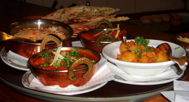 A complete meal with vegetable side dish, pullao rice and naan A complete meal with vegetable side dish, pullao rice and naan